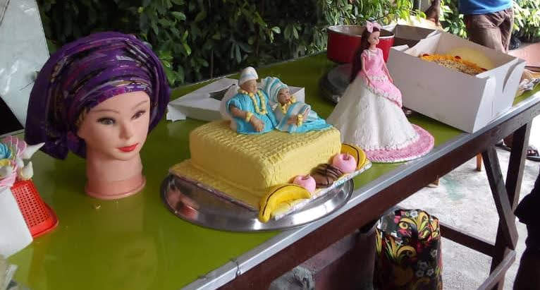 Decorated cakes and gele tying mannequin from training