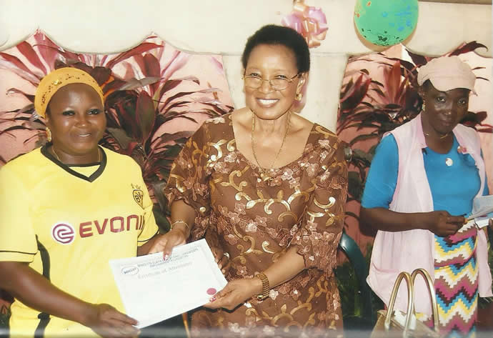 Trainee receiving a certificate of attendance from Lady Benedicta