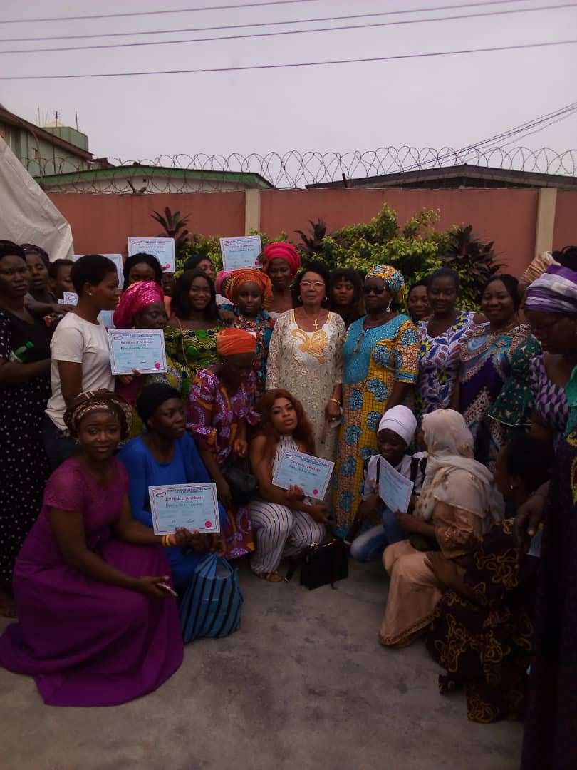 Trainees holding their certificates after graduation