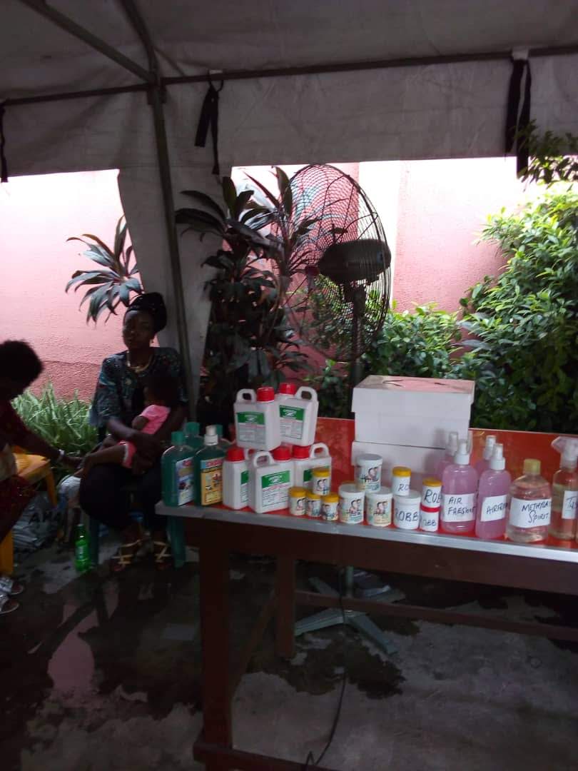Trainee with her child beside a display of homemade products